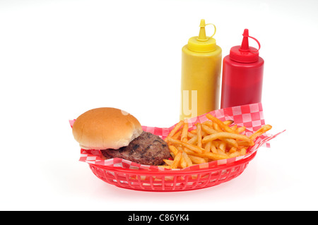 Hamburger with french fries in a red plastic retro basket with mustard and ketchup condiments on white background, cutout. USA Stock Photo