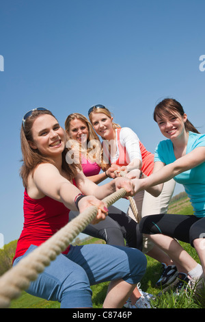 Young Women Pulling on Rope Stock Photo