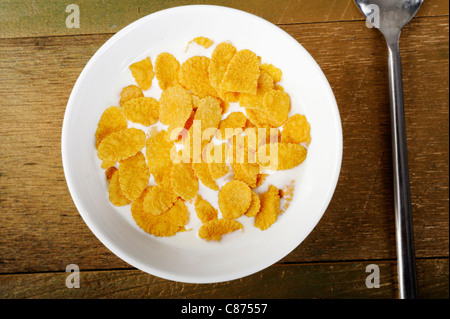 Cornflakes and milk in bowl Stock Photo