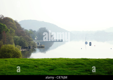 Ullswater lake at dawn with yachts and reflections and heavy mist Stock Photo