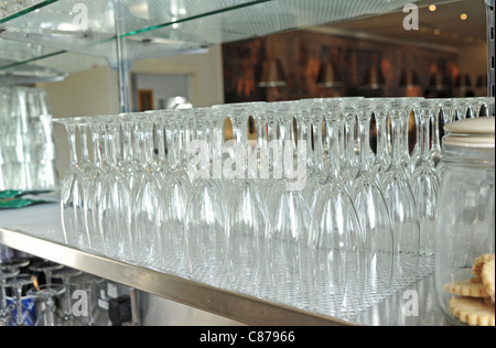 Line of champagne flute wine glasses on a shelf Stock Photo