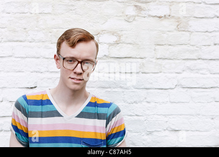 Germany, Berlin, Close up of young man with glasses, smiling, portrait Stock Photo