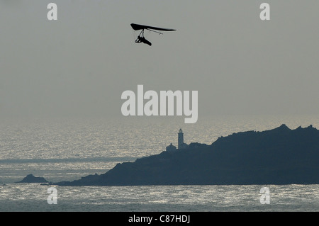 A hang glider uses the winds on the coast of South Devon overlooking Start Bay and Start Point. Stock Photo