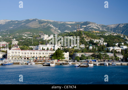 Ukraine, Yalta. Black Sea view of the port of Yalta with the Crimean Mountains in the distance. Stock Photo