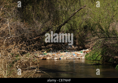 Plastic containers, tires and other pollutants collect in the Santa Cruz River, Tubac, Arizona, USA, in the Sonoran Desert. Stock Photo