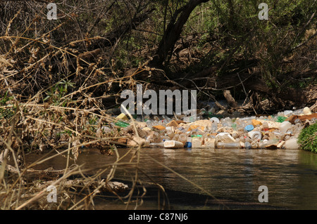 Plastic containers, tires and other pollutants collect in the Santa Cruz River, Tubac, Arizona, USA, in the Sonoran Desert. Stock Photo