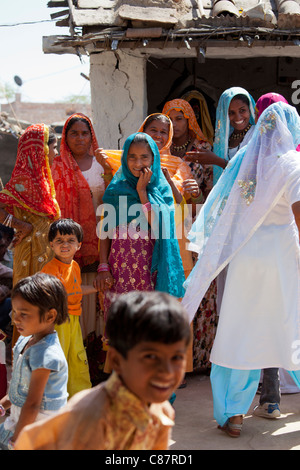 Indian wedding with guests dressed in their finest embellished saris in village of Rohet in Rajasthan, Northern India Stock Photo