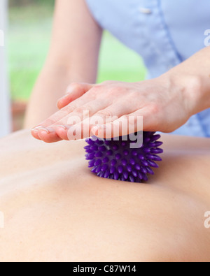 young woman having massage therapy with Spikey ball Stock Photo