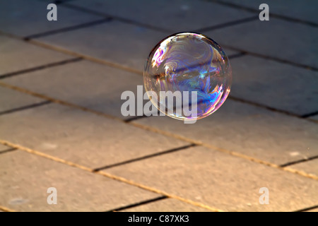 Soap bubble striking to the ground Stock Photo