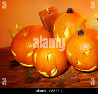 Glowing Halloween pumpkins with candles, warm autumn holiday background, traditional jack-o-lantern, night party decoration Stock Photo