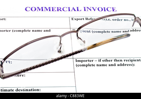 spectacles lie on the form of commercial invoice Stock Photo