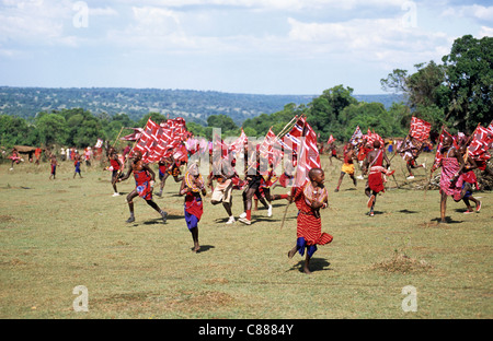 Lolgorian, Kenya. Siria Maasai; Eunoto ceremony; moran carrying flags running through the Manyatta. Stock Photo