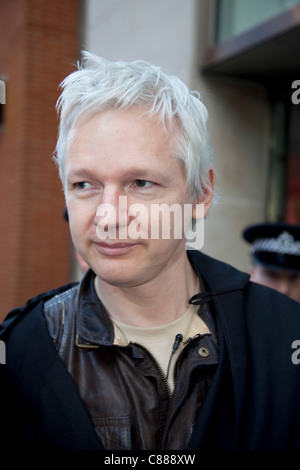 Julian Assange of WikiLeaks at the Occupy London demonstration 15th October 2011. Seen here, he tries to get through police lines wearing a black cape, hood and mask. He was immediately asked to take off the mask where upon he was dragged through, questioned and released. Stock Photo