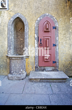 Red Carved Wood Door and a Water Fountain of the Fairytale Castle of Sintra Stock Photo