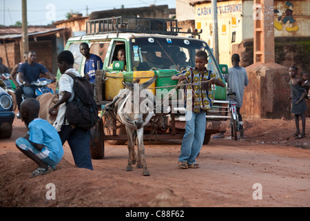 Traffic moves down a main road in Banconi, a crowded suburb of Bamako. Stock Photo