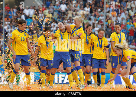 Sweden players celebrate after defeating France in the 2011 FIFA Women's World Cup third place match at Rhein Neckar Arena. Stock Photo