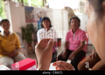 Women attend an IUD demonstration at a reproductive health clinic in Kampong Cham, Cambodia, SE Asia. Stock Photo