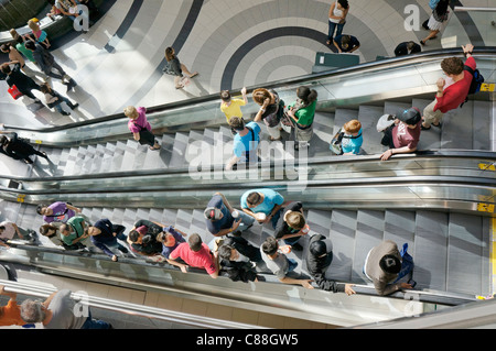 People on escalators in shopping mall Stock Photo