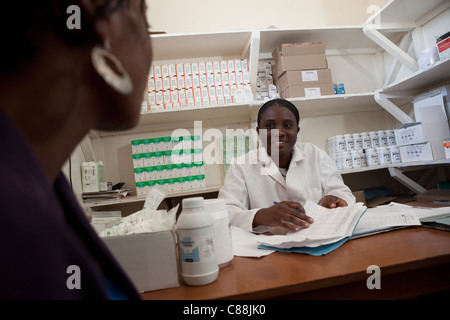 A pharmacist distributes ARV drugs to an HIV positive patient at a Catholic Relief Services-supported clinic in Kitwe, Zambia. Stock Photo