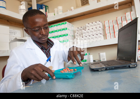 A pharmacist fills a prescription at an AIDS Relief clinic supported by Catholic Relief Services in Kitwe, Zambia. Stock Photo