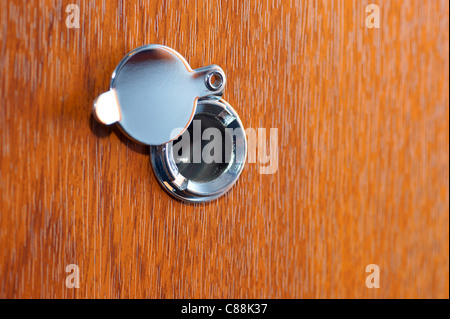 Peephole on wooden door Stock Photo