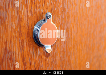Peephole on wooden door Stock Photo