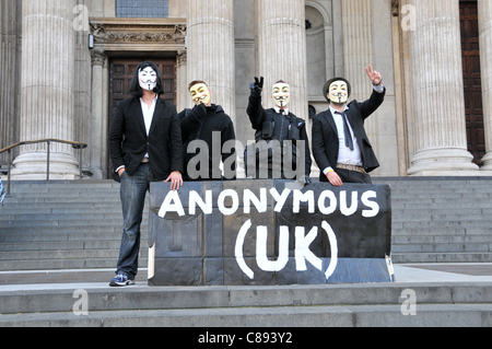 Anonymous UK protesters wearing Guy Fawkes masks Anti Capitalists create a tent city in St Paul's Courtyard near The London Stock Exchange on the second day of Occupy London. Sunday 16th October 2011