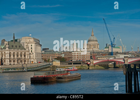London skyline including St Paul's Cathedral across the Thames, showing barges in the river and Blackfriars Bridge. Stock Photo