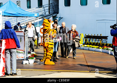 A man dressed as a tiger welcoming cruise passengers in Hyuga, Japan. Stock Photo