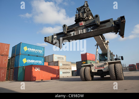 A reach stacker machine is used for moving containers outside a warehouse in the Tanzanian port city of Dar es Salaam. Stock Photo