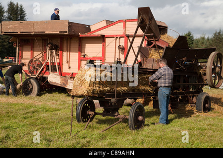 Vintage threshing machine in action Stock Photo