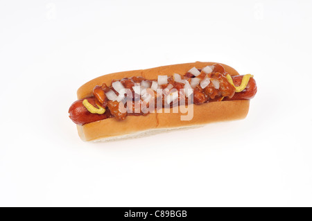 Chili dog with onions and mustard in bread roll on white background cut out Stock Photo