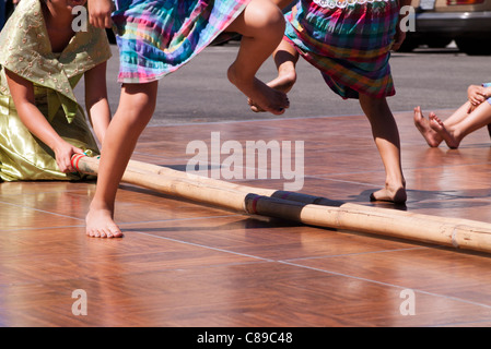 Filipino dancers performing the Tinikling a traditional Philippine folk ...