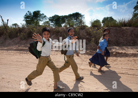 Indian schoolboys and girls walking to school at Doeli in Sawai Madhopur, Rajasthan, Northern India Stock Photo