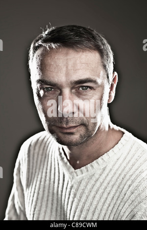 Close up of mature man against black background, smiling, portrait