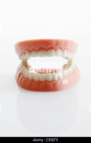 Dentures made of sugar and white chocolate on white background, close up Stock Photo