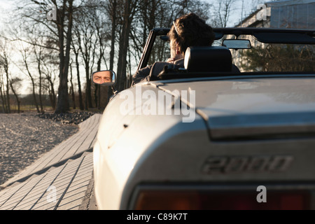 Germany, Hamburg, Man driving classic cabriolet car Stock Photo