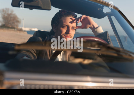 Germany, Hamburg, Man driving classic cabriolet car Stock Photo