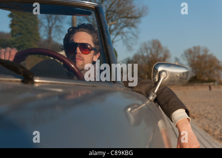 Germany, Hamburg, Man driving classic cabriolet car Stock Photo