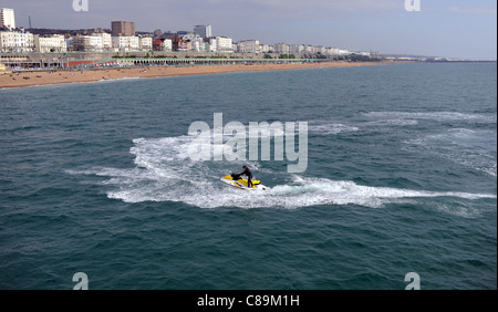 A jet skier enjoying themselves off Brighton beach and seafront UK ...