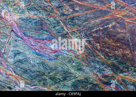 Fragment of multicolored fancy marble surface vith veins as an abstract landscape Stock Photo