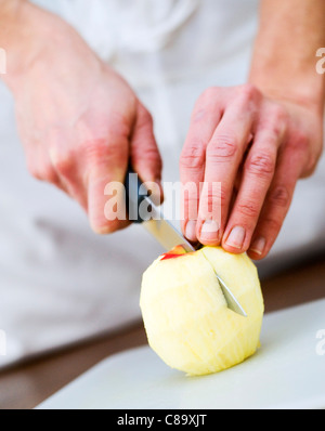 Cutting an apple in half Stock Photo