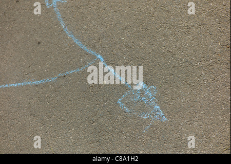 Child's chalk drawing on pavement or path in park playground Stock Photo