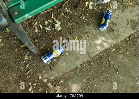 Empty larger or beer cans left by park bench Stock Photo