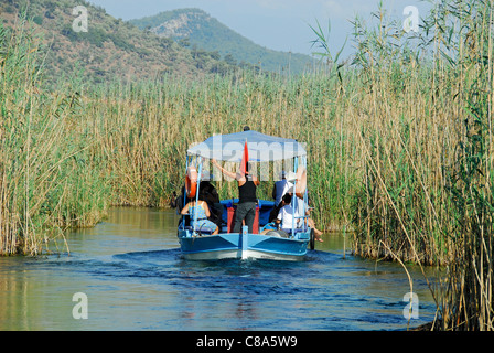 AKYAKA, TURKEY. A small pleasure boat taking holidaymakers along the Azmak river in the Gokova conservation area. 2011. Stock Photo