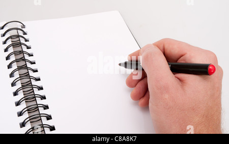 Close up of Hand With Red Marked - Open Notebook- Personal Organizer Stock Photo