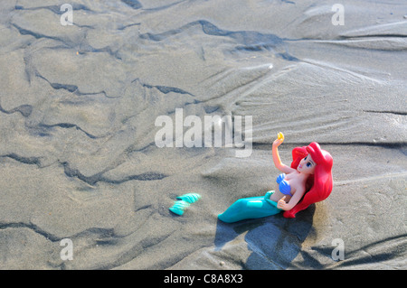 Toy mermaid found lying in the sand at low tide after the crowds left ...