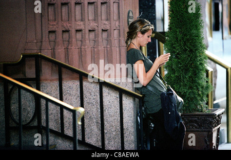 A woman sends a text message in Denver Colorado, 10/11. Shot on Kodak 400NC film. Stock Photo