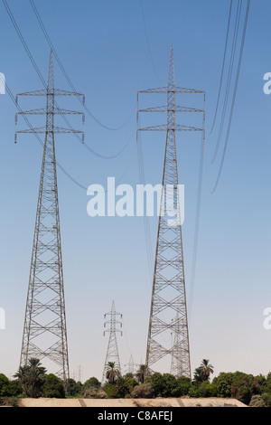 Looking directly up underneath two large electrical pylons with more in the distance, Egypt Stock Photo