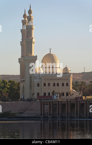 Large mosque on the banks of the Nile at Aswan with two minarets reflected in the still water, Aswan, Egypt, Africa Stock Photo